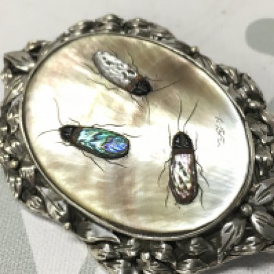 A silver shibayama bug brooch . Postage category a