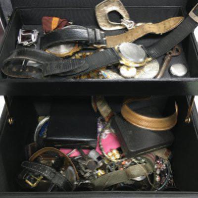 A box of costume jewellery and watches.