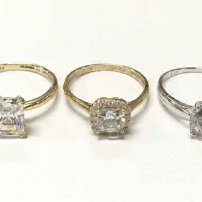 Three 9 carat gold rings set with cubic zirconia stones , size P. 6.6g total weight. Postage category A