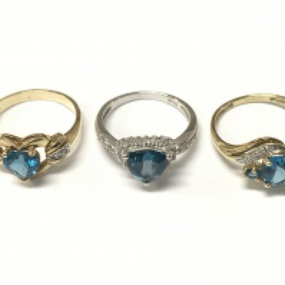 9 carat gold blue topaz set rings . 8.6g total weight. Sizes P & Q. Postage cat a