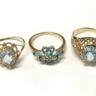 9 carat gold blue topaz rings . 8.4g total weight. Sizes P, O and Q. Postage category A