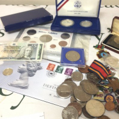 A collection of Coins including 1986 commemorative Liberty coins cased badges including 1950s Butlins badges coins including some silver coinage a II world War Burma Star bank notes and other coins