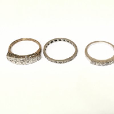 A 9ct gold diamond half eternity ring 2.22g and two white metal rings one with diamonds and one with white stones. Sizes I M and N