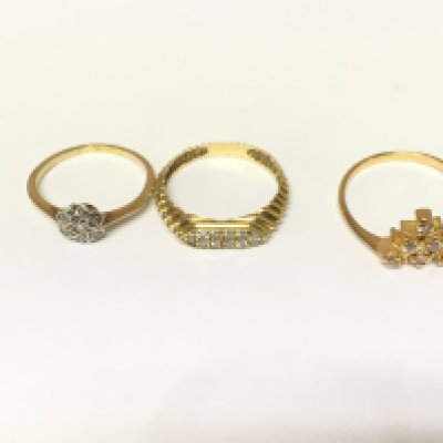 Three unmarked rings two set with diamonds and one set with white stones. Approximately 6.4g and sizes L N & P