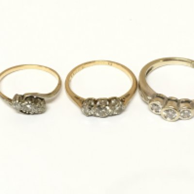 Three unmarked three stone diamond rings. Approximately 7.4g and sizes J L and M1/2