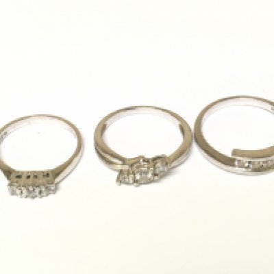 Three 9ct white gold three stone rings two with diamonds one with white stones. Approximately 7.6g and sizes L N 1/2 and P