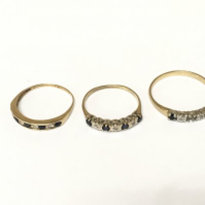 Three 9ct gold diamond and sapphire half hoop rings. Approximately 4.7g and sizes P and V