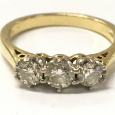 An 18ct yellow gold 0.75ct trilogy diamond ring . 3.9g total weight. Size O. Postage category A