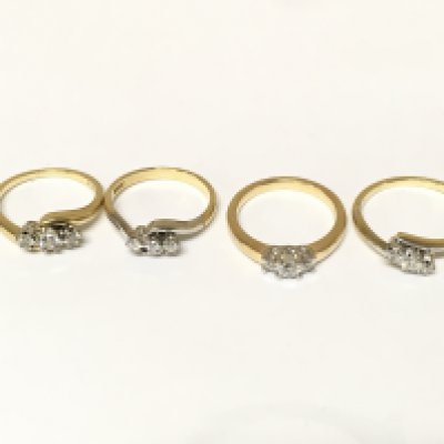 Four 18ct gold 3 stone diamond rings. Approximately 13.5g and sizes J L and O