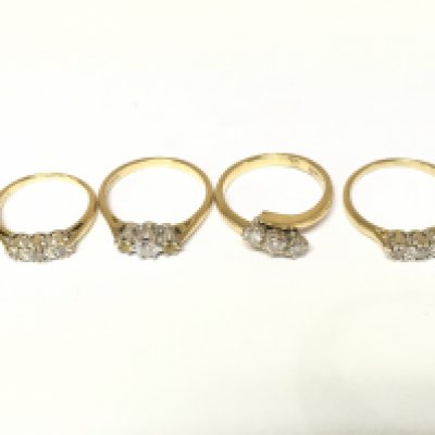Four 18ct gold 3 stone diamond rings. Approximately 11.5g and sizes H M and N
