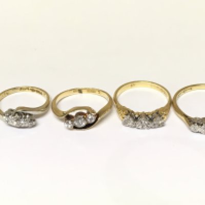 Four 18ct gold 3 stone diamond rings. Approximately 10.5g and sizes H K L and O