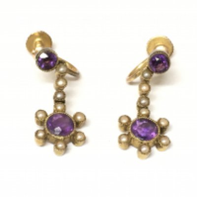 An Edwardian pair of 15ct gold seed pearl and amethyst screw back earrings.