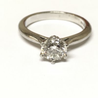 A platinum ring set with a 0.90ct diamond solitaire with GIA report. Size J and 4.54gPostage B