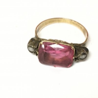 An unmarked yellow metal ring set with tourmaline and rose cut diamonds. Size K and 3.79g