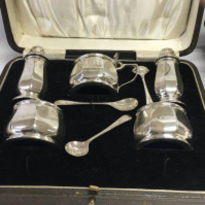 A five piece silver cruet set in original case .
