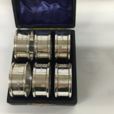A cast set of six silver napkin rings 48 grams,