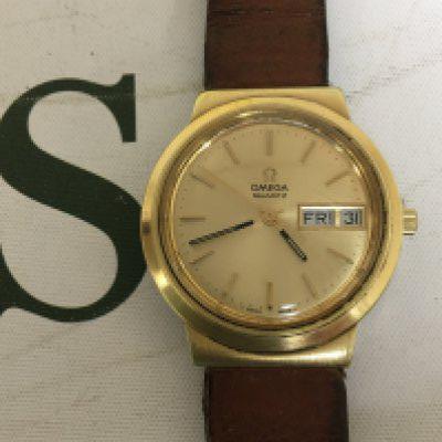 A Gents Omega mid 1970s watch gold plated case gold colour dial with day date aperture the reverse with personal inscription and date 1978. Not seen working all dial adjustments hands day date working.
