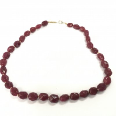 Necklace strung with polished reconstituted faceted ruby bead. Approx 280ct total.