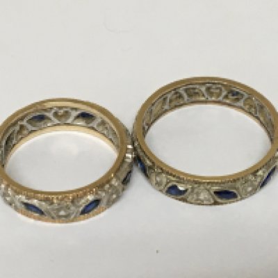 Two unmarked gold and white metal eternity rings set with sapphire and chip diamond. (2) weight 7g.