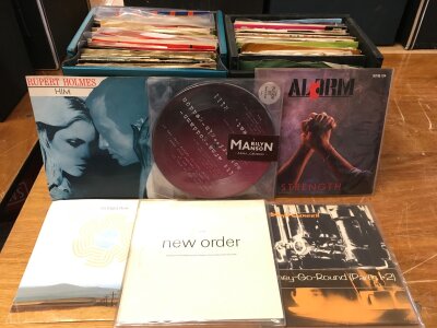Eight record cases of 7" singles and EPs by various artists including New Order, Iron Maiden, Marilyn Manson, Franz Ferdinand and many more.