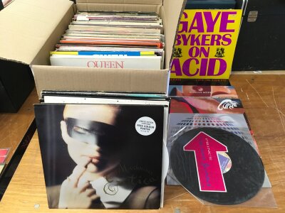 A box of 12" singles by various artists including New Order, Queen, Depeche Mode, The Cure, Madonna and many more.