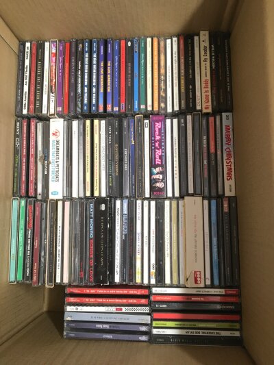 Three boxes of CDs by various artists including Yes, White Stripes, Green Day, Nirvana and many more.