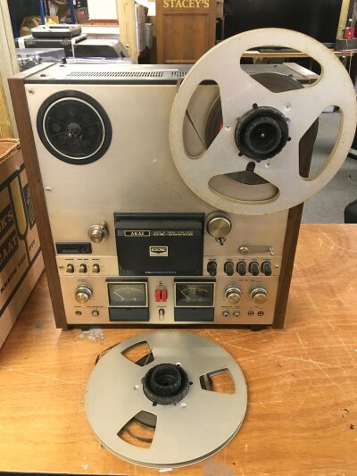A vintage Akai GX 600DB reel to reel player and a collection of reels.