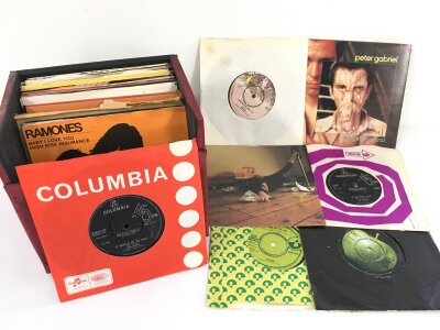 A record case of 7" singles including It Would Be So Nice b/w Julia Dream by Pink Floyd and releases by Alice Cooper, Genesis, The Beatles and others.