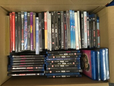 Three boxes of DVDs and BluRays comprising many music documentaries, TV shows, films etc. Many still sealed.
