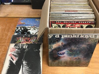 A box of LPs comprising rock and progressive albums by various artists including The Rolling Stones, Pink Floyd, Hawkwind and others.