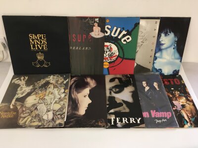 Two bags containing twenty rock and pop LPs and 12" singles by various artists including Kate Bush, Simple Minds, Phil Collins and others.