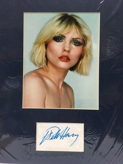 A framed and mounted Debbie Harry autograph and photo with UACC registered COA. Approx 33cm x 46cm.