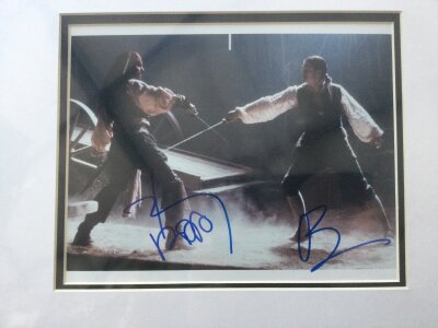 A Johnny Depp and Orlando Bloom signed photo from Pirates Of The Carribean, approx 39cm x 33cm including mount.