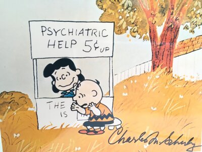 Two signed A4 Peanuts cartoons signed by Charles M Schulz with COAs.