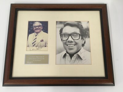A framed and glazed signed Two Ronnies display, approx 49cm x 32cm.
