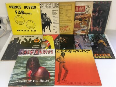 Two bags containing 25 reggae and ska LPs and 12" singles by various artists including Prince Buster, Peter Tosh, Junior Byles and others.