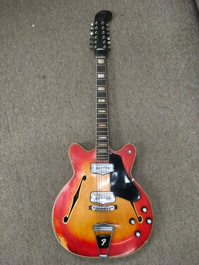 A Fender Coronado XII 12 string electric guitar in a sunburst finish. Serial on neck plate 183038. Age related wear. No case.