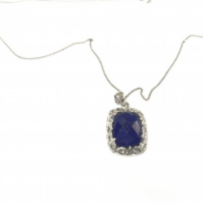 A silver pendant set with a cushion cut checkerboard lapis lazuli gemstone in an ornate mount on silver chain. Postage B
