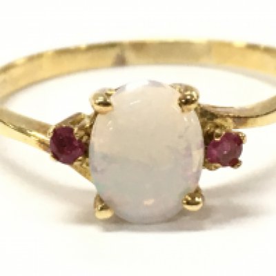 An 18ct ruby and opal ring , 2.4g total weight. Size S. Postage category A