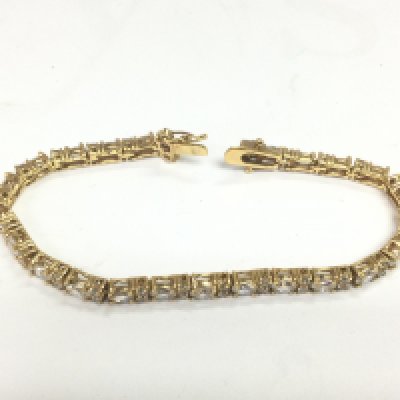 A yellow metal bracelet set with CZs. Shipping category A.