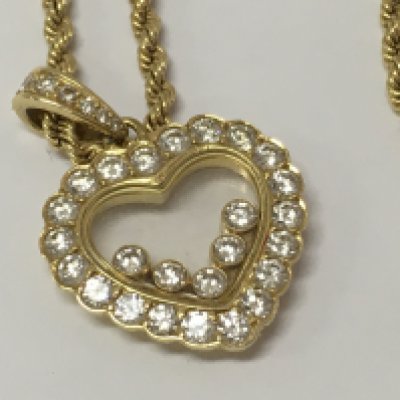 A Chopard Happy diamond 18ct yellow gold heart pendant, the frame inset with five floating round cut brilliant diamonds with attached rope chain .fitted in original box .