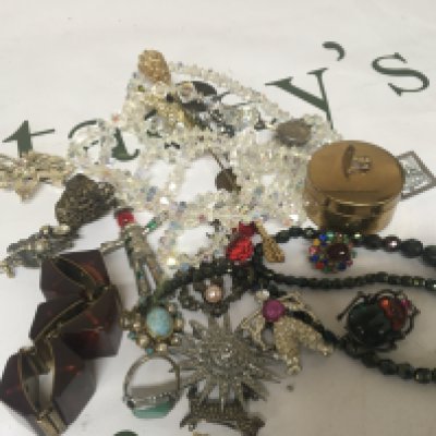 A collection of costume jewellery including a Beatle brooch and other brooches rings and oddments.- NO RESERVE
