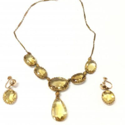 A 14ct gold citrine necklace with 5 oval citrines gold flower links and tear shaped citrine drop. Approx 38cm length and 23.7g with matching 14ct gold oval citrine screw back earrings. 15mm by 12mm and 7.7g Postage B