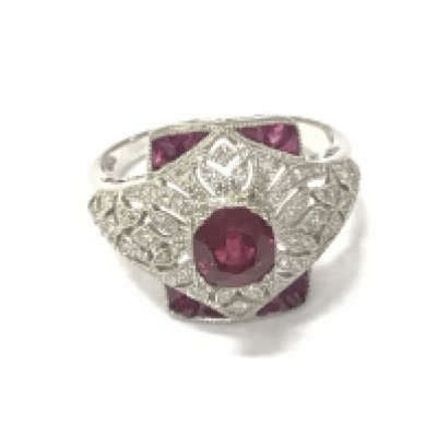 A Victorian style platinum Ruby and diamond dress ring with an ornate setting. Rubies 1ct and diamonds 0.58ct approximately. Size M 1/2.Postage B