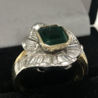 An 18ct gold emerald and diamond ring with valuation report. Size S. 12g total weight. postage catA