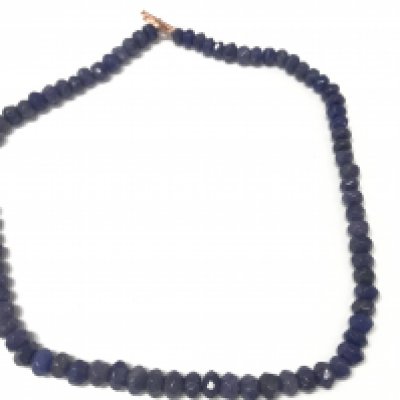 A necklace strung with faceted reconstituted blue onyx beads with a rose and bar clasp. Approximately 350 ct onyx.