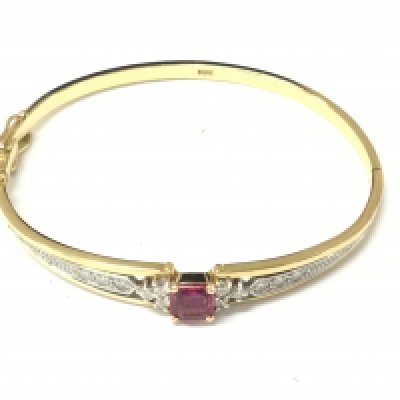 An 18ct gold ruby and diamond bracelet. 19.01g and approximately 6.5cm diameter. Postage B