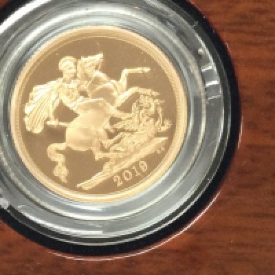 A 2019 gold proof sovereign with box and COA. Postage B