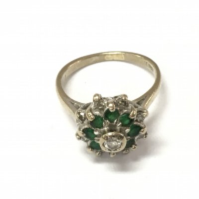 An 18ct gold diamond and emerald cluster ring. Size H 1/2 and 4.25g Postage A
