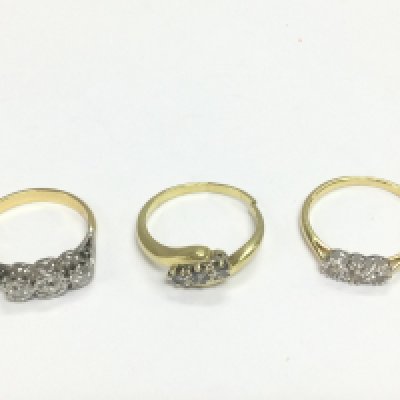 Three 18ct gold three stone diamond rings, approx sizes M, P and Q. Shipping category A. Approx total 9g. Shipping category A.